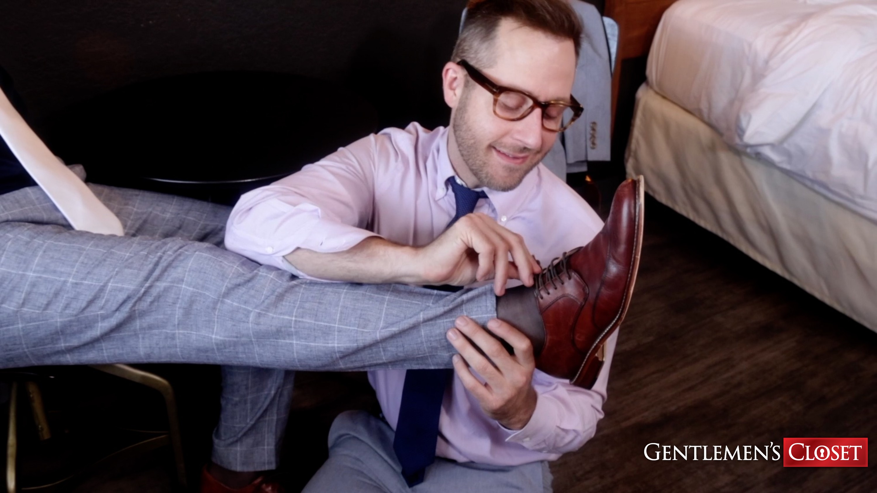 Many takes off his buddy's brown dress shoes