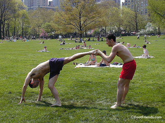 Men playing footsie in the park