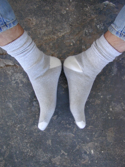 sexy male feet in socks with heels together