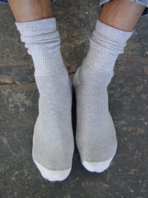 man's feet in white crew socks