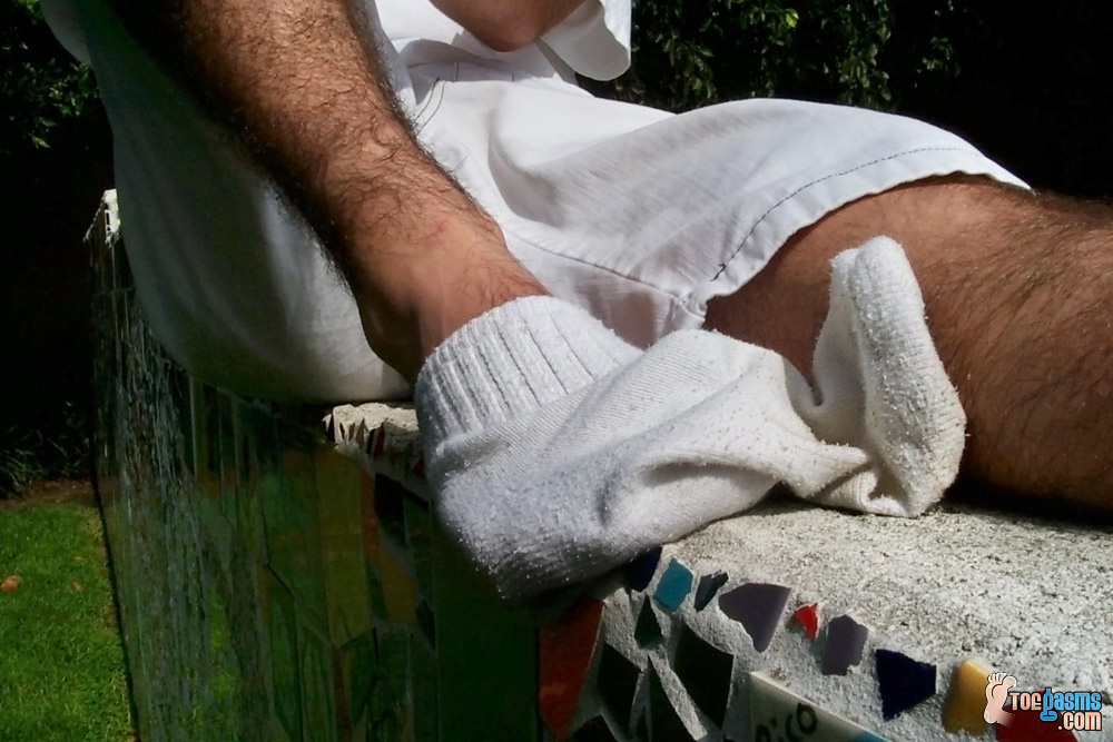 Amateur shows his hairy legs while taking off his white socks